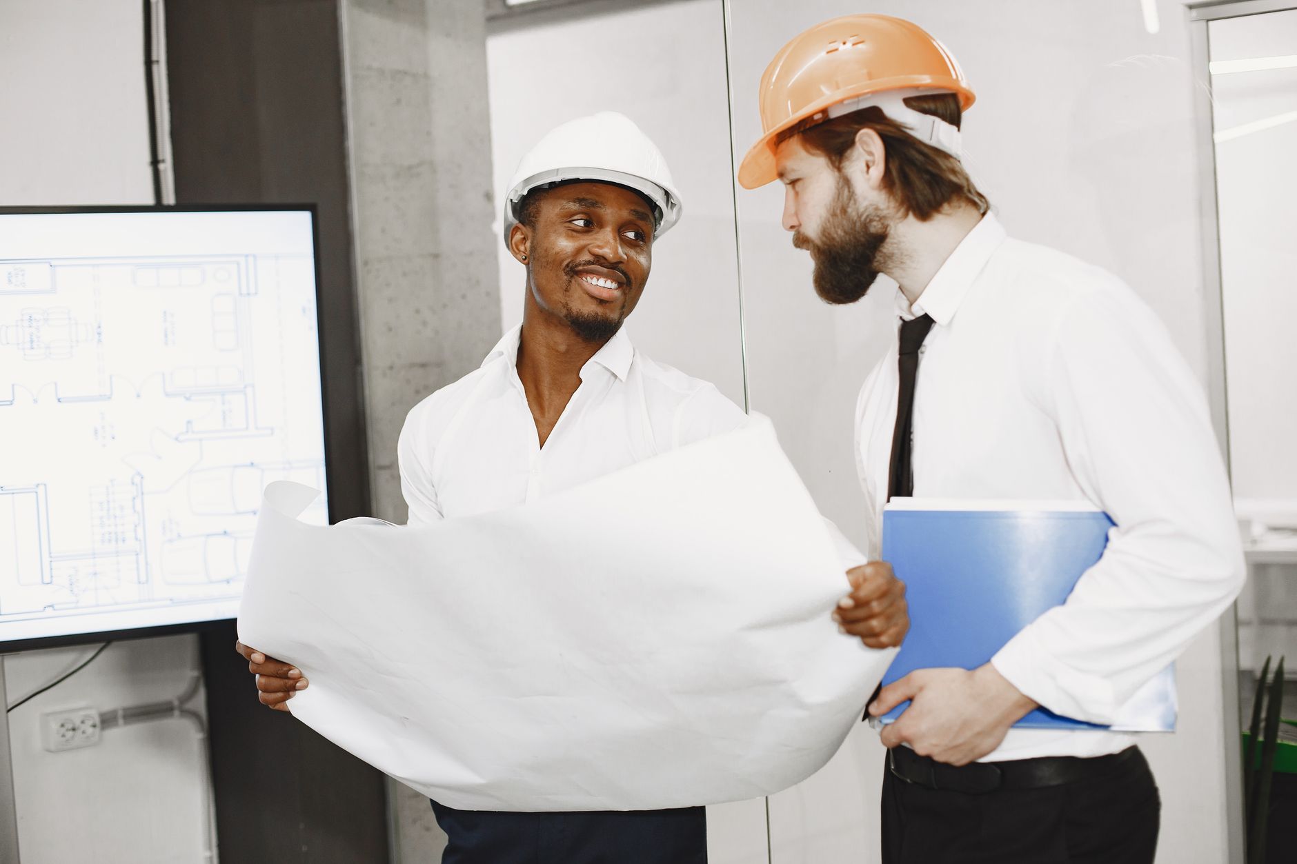 men reviewing architectonic plans together