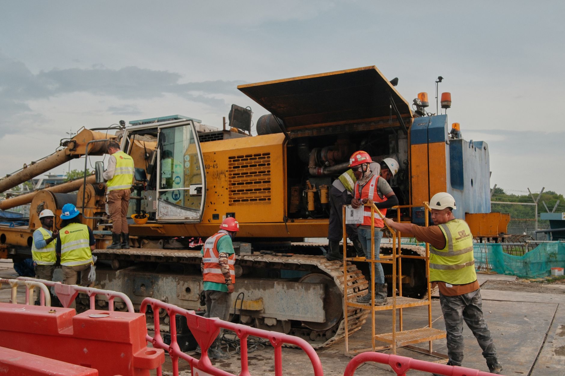 construction workers operating heavy machinery onsite