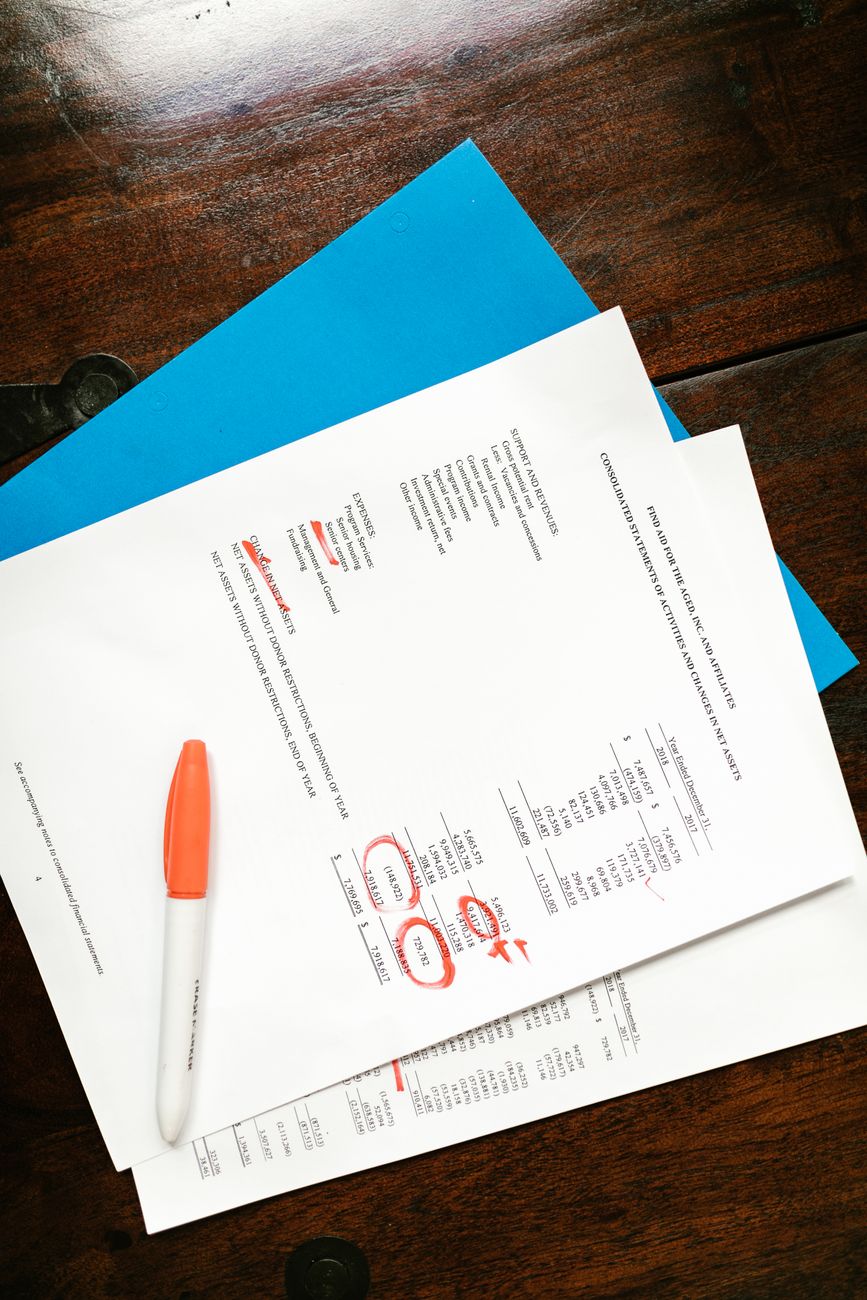 financial documents on wooden surface